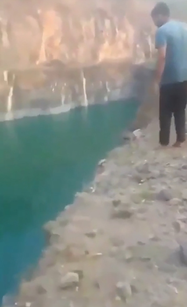 A young man, 18 years old, records a video of himself jumping into the lake